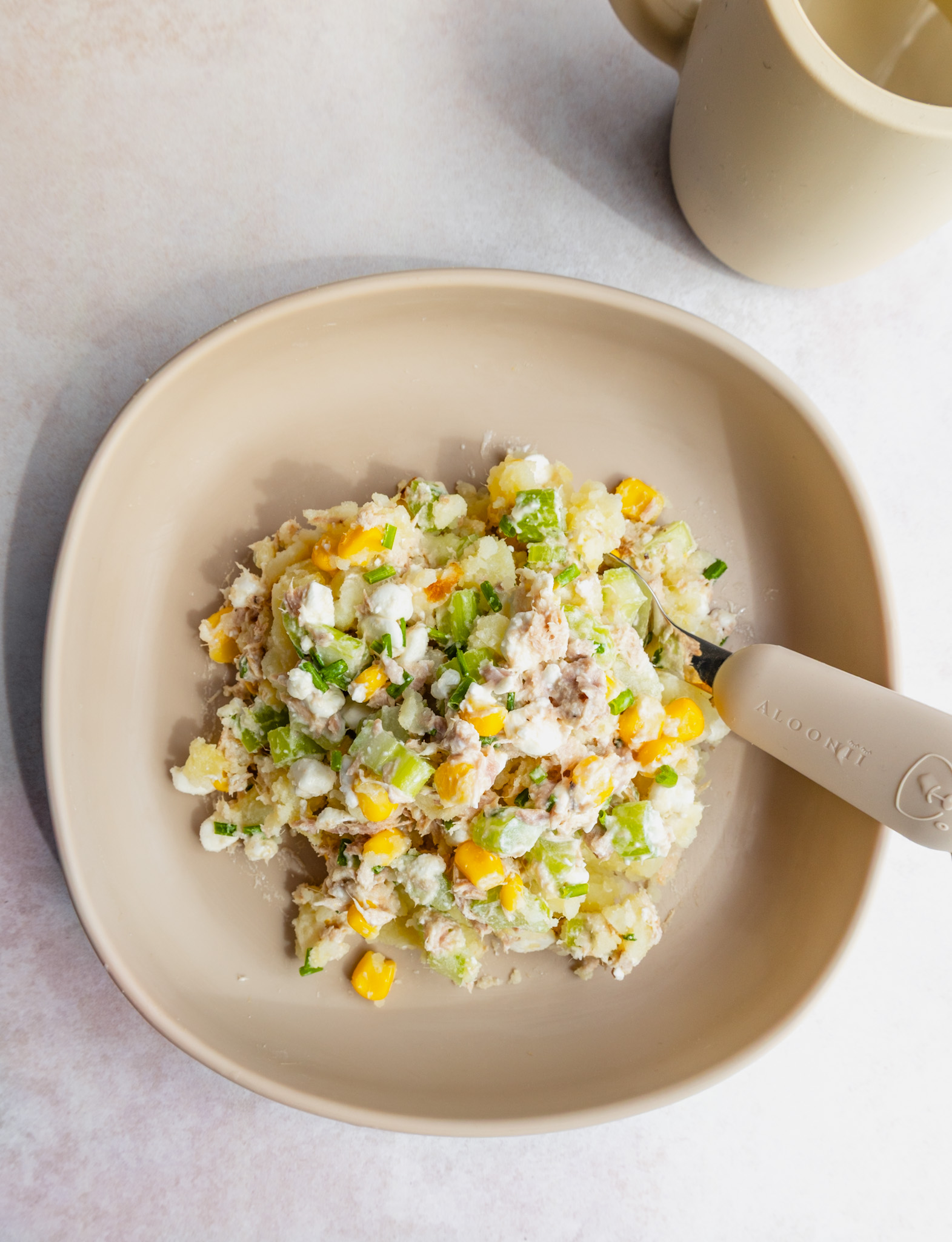 Toddler serving of baked potato topped with salad