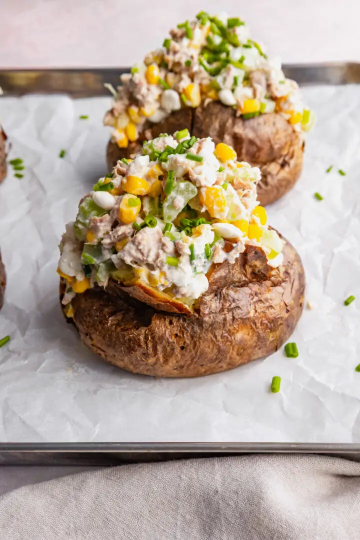Jacket potatoes topped with tuna cottage cheese, celery, sweetcorn, chive salad