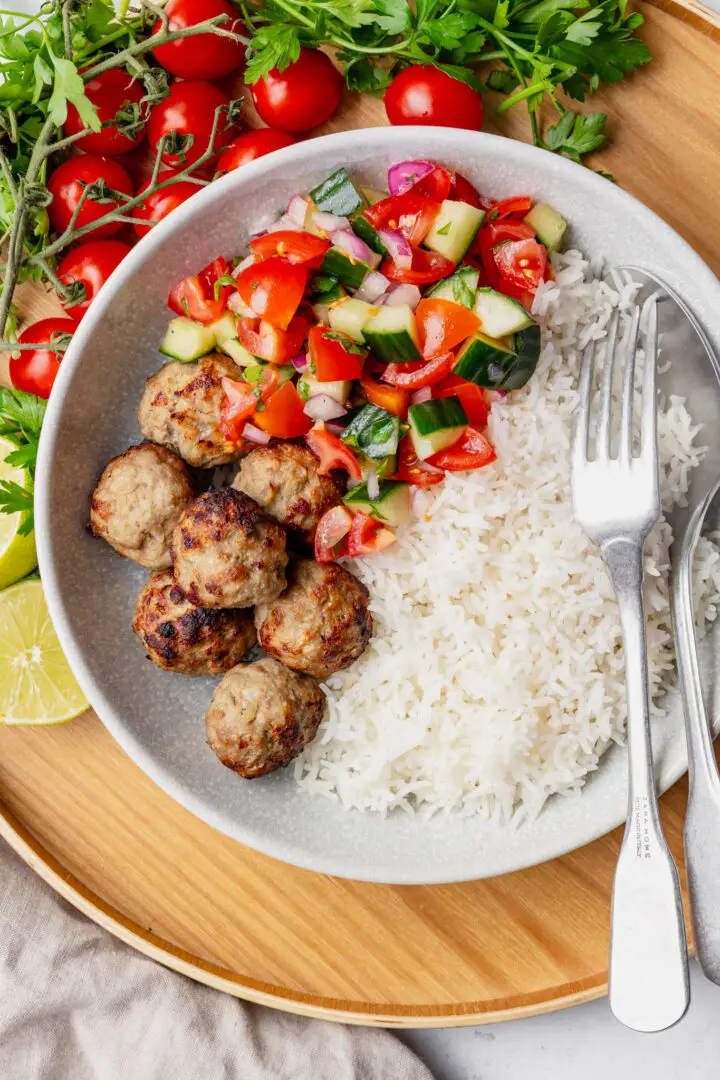 lamb meatball bowl - rice and salad On a tray